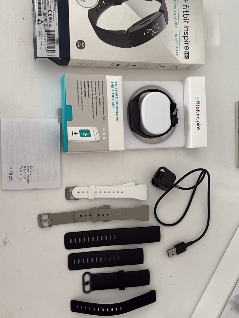 fitbit Inspire HR Tracker with Black, White, and Gray Bands